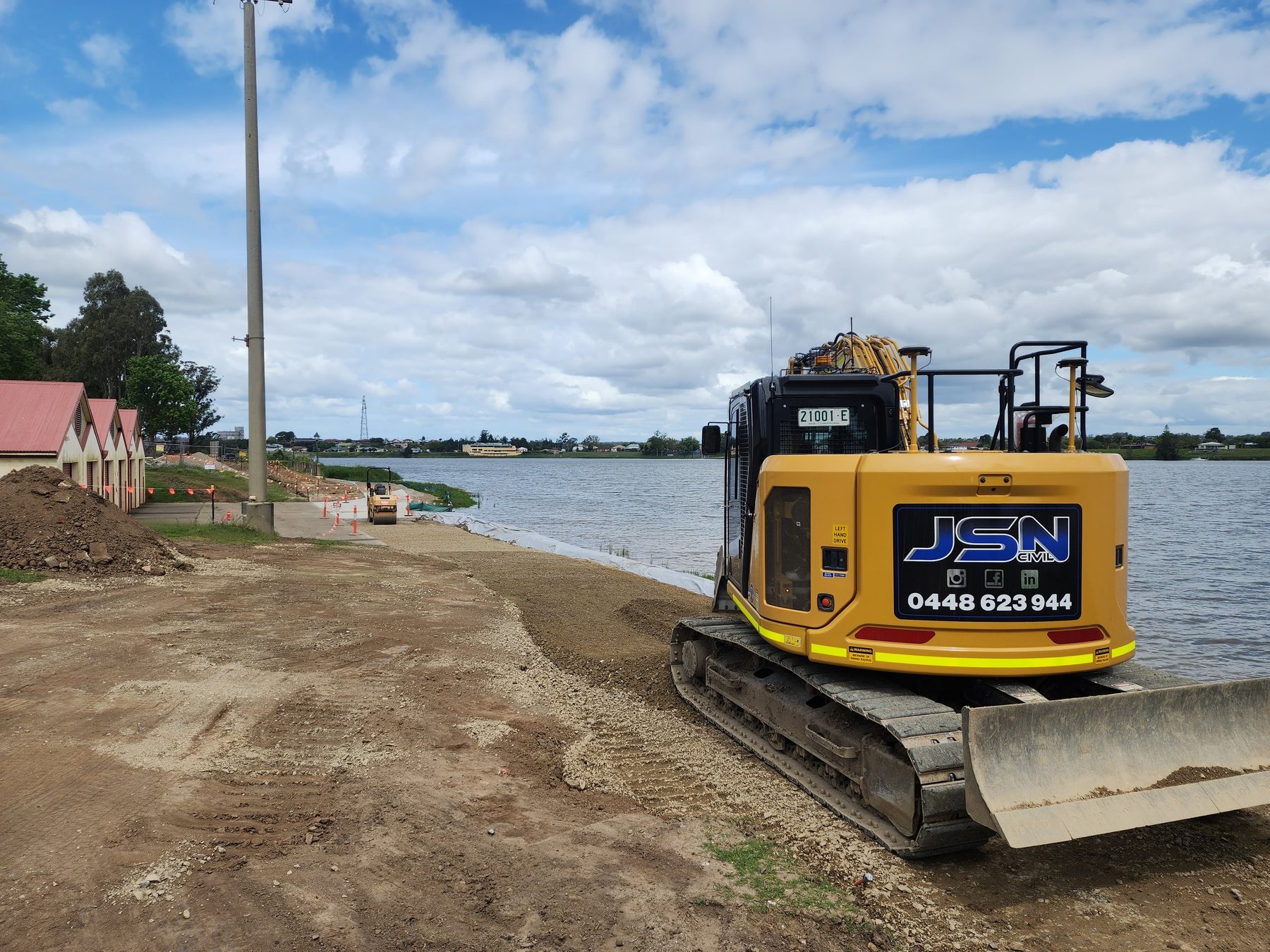 JSN Civil excavator working beside water